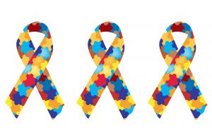 Three autism ribbons with multicolor puzzle pieces.