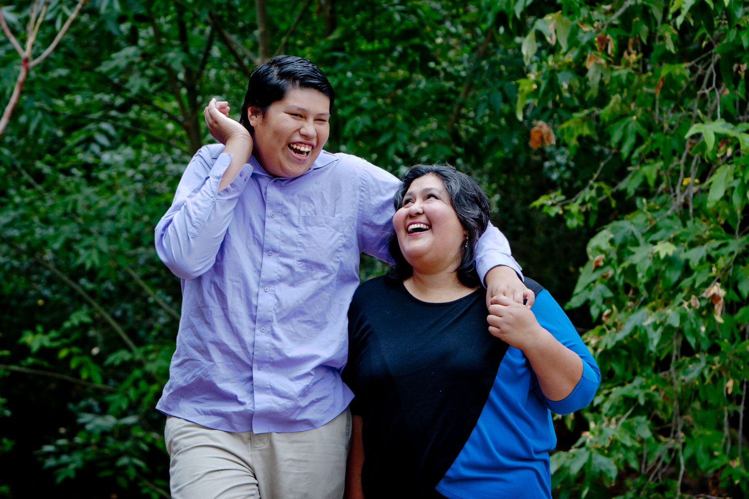 Young adult man with disabilities jokes around with his mom