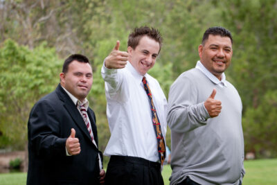 two people served by TCRC and a service provider give the thumbs up